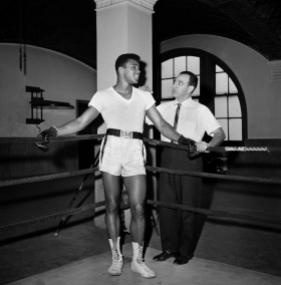Young heavyweight fighter Cassius Clay is seen with his trainer Angelo Dundee at City Parks Gym in New York, Feb. 8, 1962