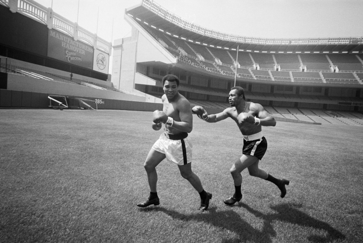 Boxer Ken Norton playfully chases champion Muhammad Ali across the field at Yankee Stadium. Norton lost the title fight to Ali at the stadium on September 28, 1976. (Marty Lederhandler/AP Photo)